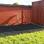 Grass Mats Behind Shipping Container In Horse Paddock - Featured Image