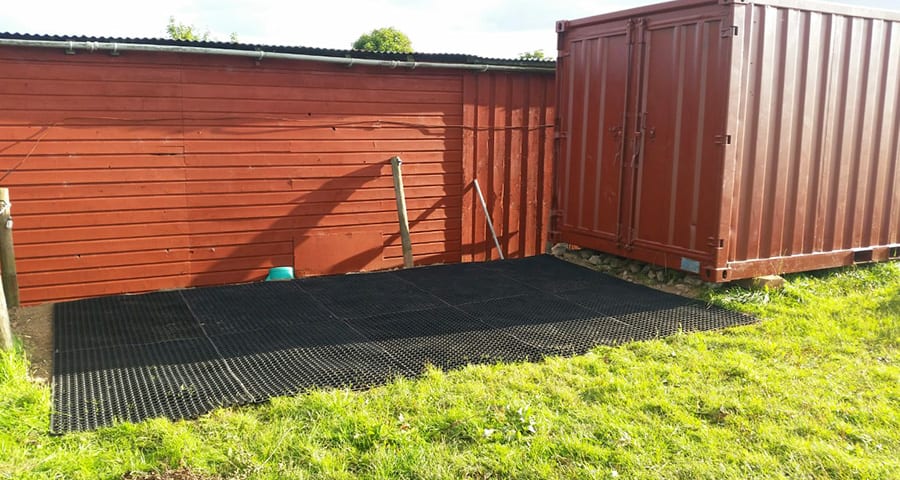 Grass Mats Behind Shipping Container In Horse Paddock - Featured Image